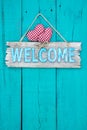 Welcome sign with hearts hanging on door