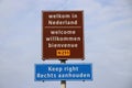 Welcome sign at Hoek van Holland for travelers from England with warning to keep right for driving lane.