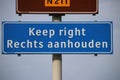 Welcome sign at Hoek van Holland for travelers from England with warning to keep right for driving lane.