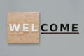 Welcome sign set on a wood background and grey cement Royalty Free Stock Photo