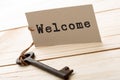 Welcome - tag on vintage key, check-in hotel concept Royalty Free Stock Photo