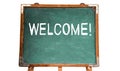 Welcome! text message in white chalk written on a school green old grungy vintage wooden chalkboard or blackboard Royalty Free Stock Photo