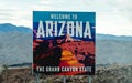 welcome to arizona sign standing outside near the mountains in the desert