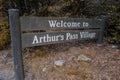 Welcome to Arthur`s Pass Village sign, wooden street sign, in Arthur`s Pass, Canterbury, New Zealand