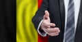 Welcome to the Belgium. Hand on Belgian flag background. Business, politics, cooperation and travel concept Royalty Free Stock Photo