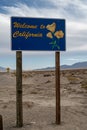 Welcome to California road sign in desert with mountains Royalty Free Stock Photo