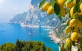 Welcome to Capri concept image. Daylight view of Marina Piccola and Monte Solaro, Capri Island, Italy. Ripe yellow lemons in