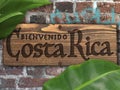 Welcome to Costa Rica Sign on Brick Wall with Tropical Plants Bienvenido Royalty Free Stock Photo