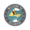 Welcome to Delaware. Gray stamp with a waving state flag.