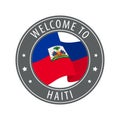 Welcome to Haiti. Gray stamp with a waving country flag.