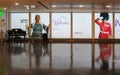 Welcome to Heathrow Airport - View with grand piano and images of multicultural people greeting travelers entering Heathrow London