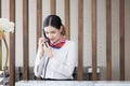 Welcome to the hotel,Happy young Asian woman hotel receptionist worker smiling standing,she taking telephone call at a Modern Royalty Free Stock Photo