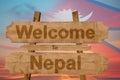 Welcome to Nepal sign on wood background with blending nationa
