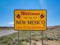 Welcome to New Mexico Land of Enchantment road sign at state crossing