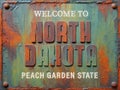 Welcome to North Dakota rusted street sign