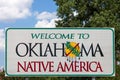 Welcome to Oklahoma sign with blue sky and trees in the background Royalty Free Stock Photo