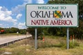 Welcome to Oklahoma sign with blue sky and trees in the background Royalty Free Stock Photo