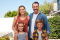 Welcome to our home. Portrait of a happy young family spending quality time in their backyard at home. Royalty Free Stock Photo