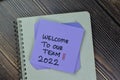 Welcome To Our Team 2022 write on sticky notes isolated on Wooden Table Royalty Free Stock Photo