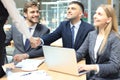 Welcome to our team. Young modern businessmen shaking hands while working in the creative office. Royalty Free Stock Photo