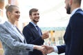 Welcome to our team. Young modern businessmen shaking hands while working in the creative office Royalty Free Stock Photo