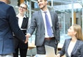 Welcome to our team. Young modern businessmen shaking hands while working in the creative office Royalty Free Stock Photo
