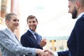 Welcome to our team. Young modern businessmen shaking hands while working in the creative office Royalty Free Stock Photo