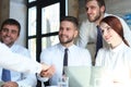 Welcome to our team. Young modern businessmen shaking hands while working in the creative office Royalty Free Stock Photo