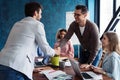 Welcome to our team! Young modern men in smart casual wear shaking hands while working in the creative office. Royalty Free Stock Photo