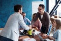 Welcome to our team! Young modern men in smart casual wear shaking hands while working in the creative office. Royalty Free Stock Photo