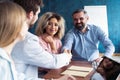 Welcome to our team! Young modern men in smart casual wear shaking hands while working in the creative office. Royalty Free Stock Photo