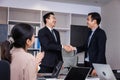 Welcome to our team of young modern men in smart casual wear shaking hands while working in the creative office Royalty Free Stock Photo