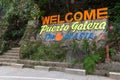 `Welcome to Puerto Galera, the heart of Asia` sign in stone, Mindoro island, Tamaraw waterfalls, popular tourist place of Philippi Royalty Free Stock Photo