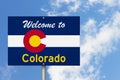 Welcome to the state of Colorado road sign in the shape of the state map with the flag Royalty Free Stock Photo