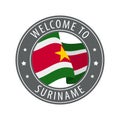 Welcome to Suriname. Gray stamp with a waving country flag.