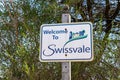 A Welcome to Swissvale, a suburb east of Pittsburgh, Pennsylvania, USA sign with shrubbery behind it