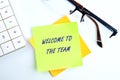 WELCOME TO THE TEAM text written on a yellow sticker on a white background Royalty Free Stock Photo