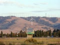 Welcome to Tehachapi World Wind Energy Leader Sign with Modern Windmills spin on hillside Royalty Free Stock Photo