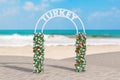 Welcome to Turkey Concept. Beautiful Decor Arc, Gate or Portal with Flowers and Turkey Sign on an Ocean Deserted Coast. 3d