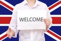 Welcome to UK Migration. World. A man holding out his hand on the background of the UK Royalty Free Stock Photo