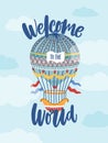 Welcome To The World phrase on greeting card, birthday celebration poster. Vintage hot air balloon flying in sky Royalty Free Stock Photo