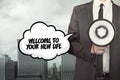 Welcome to your new life text on speech bubble with businessman and megaphone Royalty Free Stock Photo