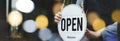 Welcome. waitress staff woman turning wooden open sign board on glass door with bokeh ligh in modern cafe coffee shop, cafe restau Royalty Free Stock Photo