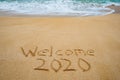 Welcome 2020 written in the sand