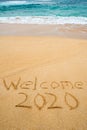 Welcome 2020 written in the sand