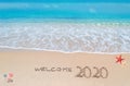 Welcome 2020 written on a tropical beach Royalty Free Stock Photo