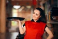 Smiling Waitress Holding Tray in a Restaurant Royalty Free Stock Photo