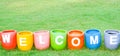 Welcoming and greetings concept with welcome word colorful on garden background. Royalty Free Stock Photo