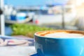 Welcoming new day with a cup of coffee at a waterfront cafe Royalty Free Stock Photo