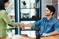 Welcoming a new member to the team. two businesspeople shaking hands in an office. Royalty Free Stock Photo